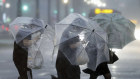 Heavy rain strikes pedestrians in Kagoshima, western Japan, ahead of Typhoon Shanshan.