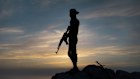A Syrian soldier stands guard in the coastal province of Latakia. Thousands of foreigners flocked to Syria to fight in the civil war that lasted almost 14 years, and many now want to stay.