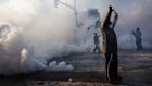 A person holds up their hands as law enforcement deploys a thick screen of tear gas on Nicollet Avenue in Minneapolis.
