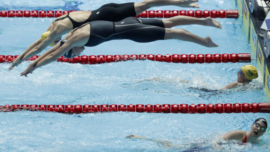 Australia’s Emma McKeon and United States Katie McLaughlin dive in together for the final leg of the women’s 4x200m relay final at the World Swimming Championships in Gwangju, South Korea, Thursday, July 25, 2019. (AP Photo/Lee Jin-man )