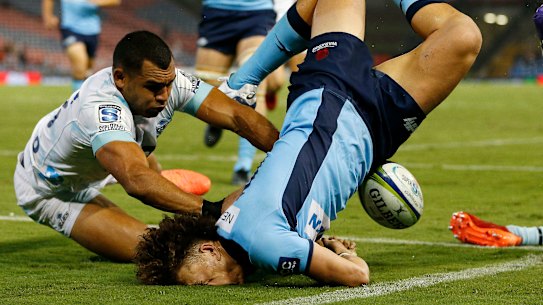 Waratahs winger Mark Nawaqanitawase left the field injured after crashing into the turf head first while scoring a try.
