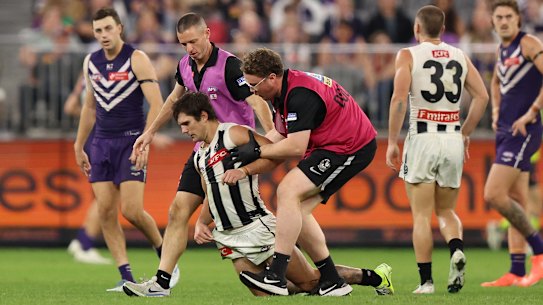 Lachie Schultz of the Magpies leaves the field injured during their round 9 match against the Fremantle Dockers.
