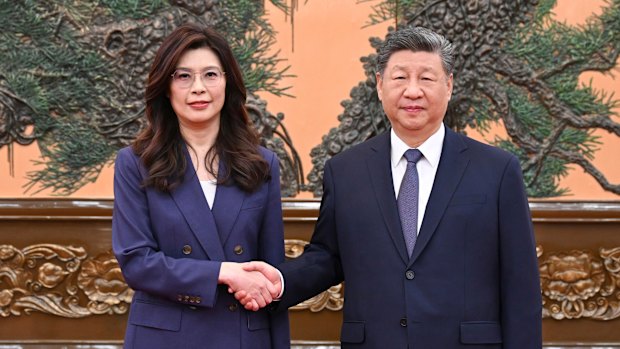 Chinese President Xi Jinping (right) shakes hands with Kuomintang (KMT) party leader Cheng Li-wun in Beijing on Friday.