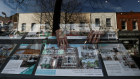 A real estate agent adjusting a sign in London. Rightmove is the biggest property listing platform in the United Kingdom.