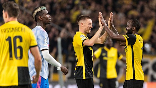 A dejected Paul Pogba watches on as Young Boys celebrate their late Champions League winner.