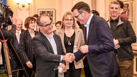 Premier Daniel Andrews shakes hands with outgoing deputy premier James Merlino.