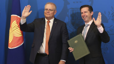 Prime Minister Scott Morrison and Trade Minister Simon Birmingham at the signing of the RCEP agreement in Canberra on Sunday. 