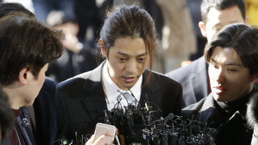 Jung Joon-young, centre, is accused of having secretly filmed himself having sex with about 10 women and sharing the footage with friends by a mobile messenger app.