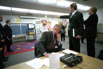President George W. Bush gathers information about the terrorist attack  from a classroom at Emma E. Booker Elementary School in Sarasota, Florida. Pictured second from left is CIA analyst  Michael Morell with other White House staff.