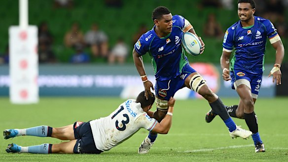 Drua No.7 Kitione Salawa is tackled by Waratahs centre Izaia Perese.