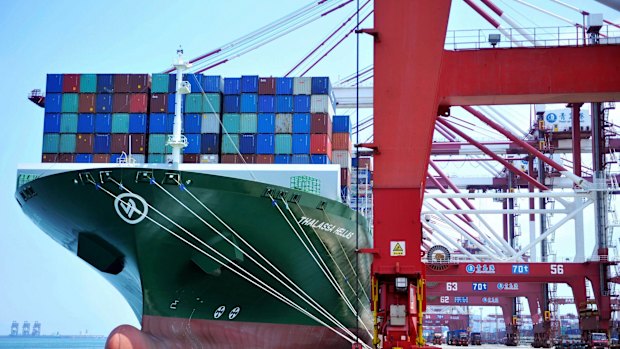 A ship hauls containers at a container port in Qingdao in eastern China's Shandong province.