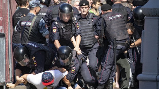 Police officers detain protesters during an unsanctioned rally in the centre of Moscow, Russia, in July 2019.
