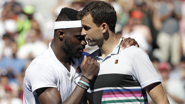 Best wishes: Dimitrov congratulates his good friend Tiafoe after the match.