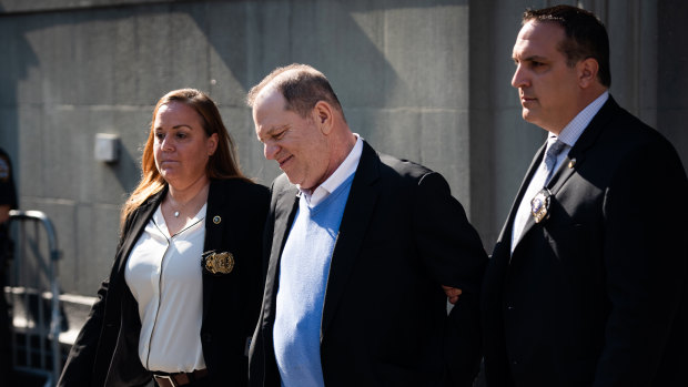 Harvey Weinstein being escorted in handcuffs out of the New York Police Department.