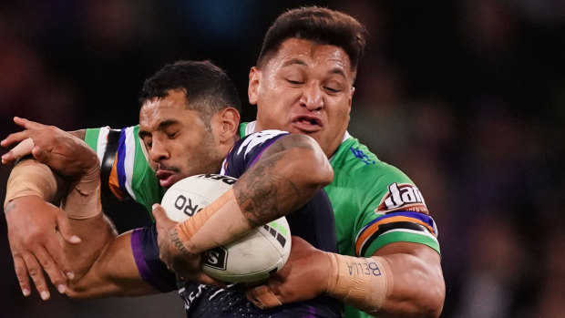 Josh Papalii tackles Josh Addo-Carr of the Melbourne Storm.
