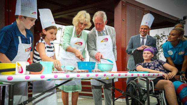 Prince Charles and Camilla make lamingtons at Lady Cilento Children's Hospital.
