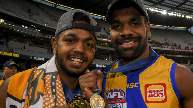 Liam Ryan (right) shows odd his premiership medal with teammate Willie Rioli.