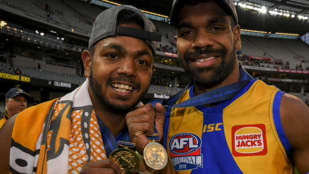 Willie Rioli and premiership teammate Liam Ryan show off their medals.