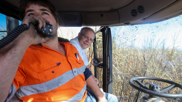Prime Minister Scott Morrison in a cane harvester with operator Anthony Corica during a visit to a Burdekin sugar cane farm in Giru.