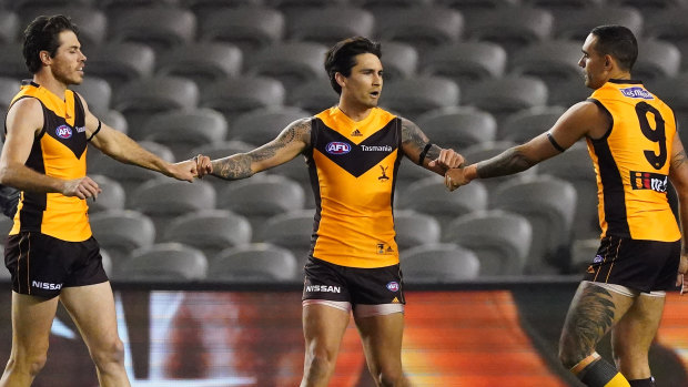 Powering up: Hawthorn's Chad Wingard celebrates with Isaac Smith (left) and Shaun Burgoyne.