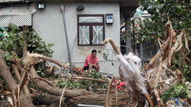 Debris sits piled up against a house at the front beach after Typhoon Mangkhut in the Shek O area of Hong Kong, China.