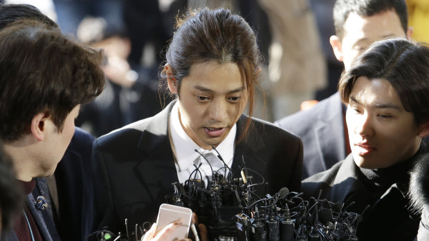 Jung Joon-young, centre, is accused of having secretly filmed himself having sex with about 10 women and sharing the footage with friends by a mobile messenger app.