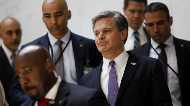 Christopher Wray, director of the FBI, centre, arrives for a meeting of law enforcement and intelligence leaders in Washington, DC. 
