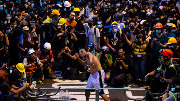 A protester throws an egg at police headquarters during a demonstrations in Hong Kong, China.
