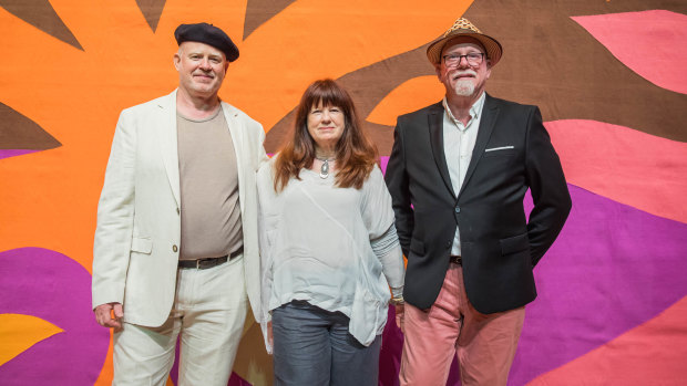 From left: Daniel Coburn, Kristin Coburn and Stephen Coburn in front of their father John Coburn's Curtain of the Sun created for the Sydney Opera House.