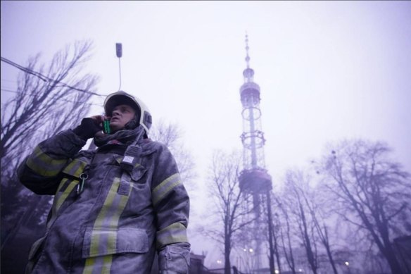 An emergency services worker responds to a Russian attack on the Kyiv television tower on Tuesday. 