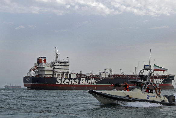 A speedboat of Iran's Revolutionary Guard circles the British oil tanker before it was taken into an Iranian port in July.