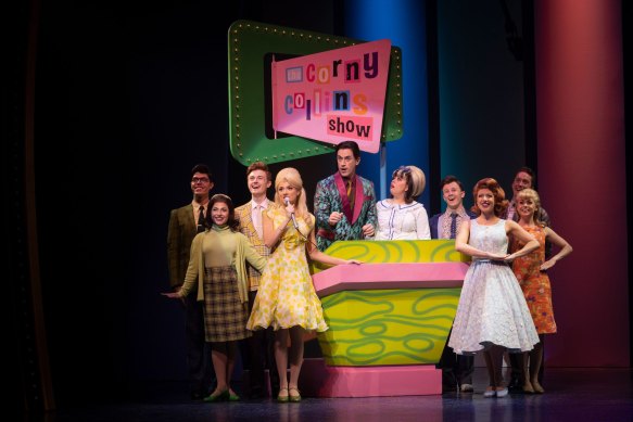 The set and costumes spike your eyeballs with the lemons and shocking pinks of the 1960s.
