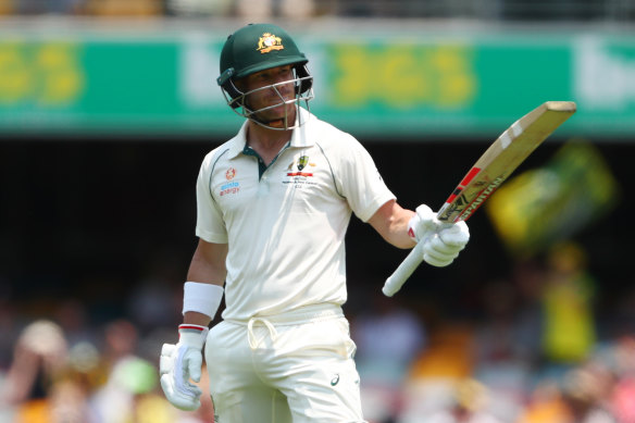 David Warner celebrates his half-century at the Gabba on day two.