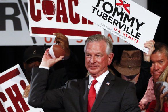 Tommy Tuberville throws toy footballs to supporters in 2020