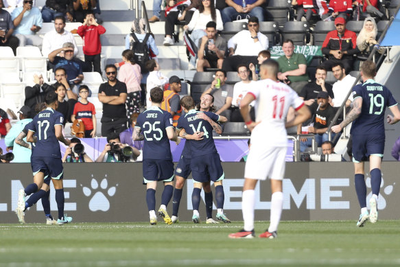 Jackson Irvine, centre, celebrates after scoring the opening - and only - goal against Syria.