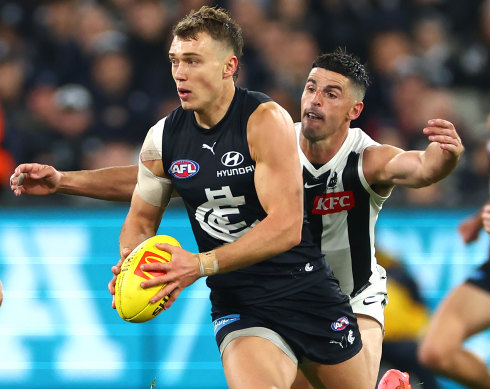 Patrick Cripps is chased down by Scott Pendlebury.