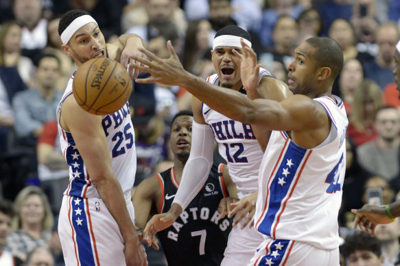 Ben Simmons, Toronto's Kyle Lowry, Tobias Harris and Al Horford battle for a loose ball.
