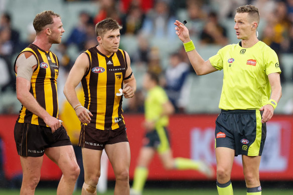 Hawthorn’s Tom Mitchell speaks to umpire Hayden Gavine after a 50-metre penalty was paid to the Cats on Easter Monday.