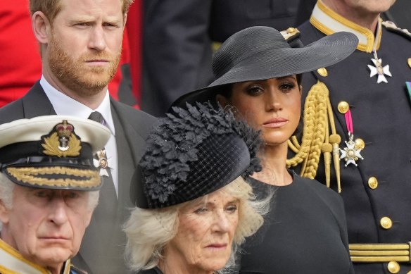 King Charles III, Camilla, the Queen Consort, Prince Harry and Meghan, Duchess of Sussex watch as the coffin of Queen Elizabeth II is placed into the hearse following the state funeral service in Westminster Abbey last year.