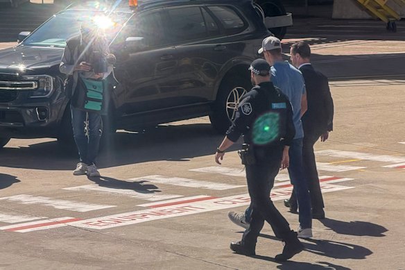 Ben Roberts-Smith is taken into custody after arriving at Sydney Airport on Tuesday.