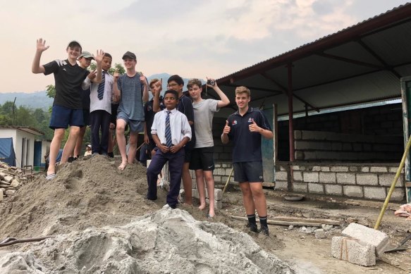 The job in Nepal by the Canberra Grammar School students involved moving 10 tonne of sand and cement.