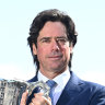 AFL chief executive Gillon McLachlan with the premiership trophy at the news conference announcing the grand final move to Queensland  on Wednesday.
