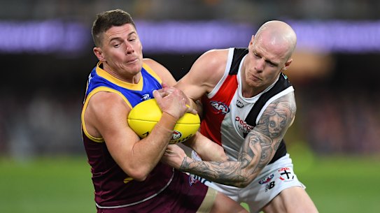 The Lions’ Dayne Zorko is tackled by Zak Jones. Both players were injured.