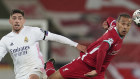 Liverpool’s Thiago, right, is challenged by Real Madrid’s Federico Valverde.