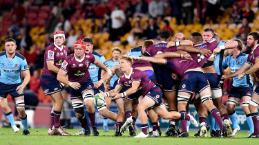 Tate McDermott passes a ball in the Reds’ win over the Waratahs at Suncorp Stadium last year. 