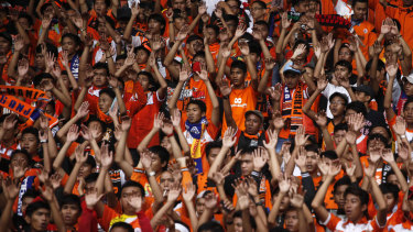 Indonesian soccer fans cheer the home team, Jakarta's Persija. The game is under pressure in the country due to violence off the pitch. 