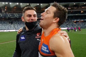 Stephen Coniglio embraces Toby Greene after GWSâ€™ last win over Geelong in round 21.