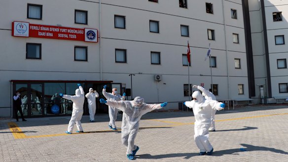 Turkish health officials perform an impromptu dance to celebrate the end of quarantine for health workers returning  from Kazakhstan and Russia.