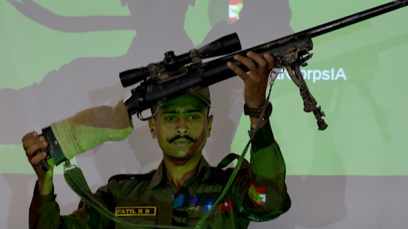 An Indian army officer displays a sniper gun recovered during a search operation along the Amarnath route, during a joint press conference in Srinagar, Indian-controlled Kashmir.