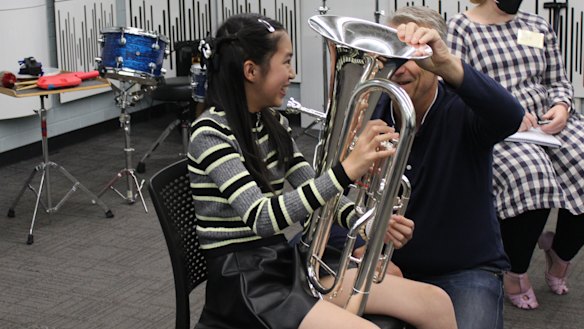 Tiana Ekpanyaskun trying out different instruments during the Adaptive Music Bridging Program.